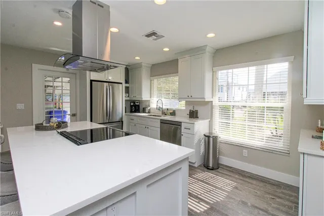 a kitchen with refrigerator and window