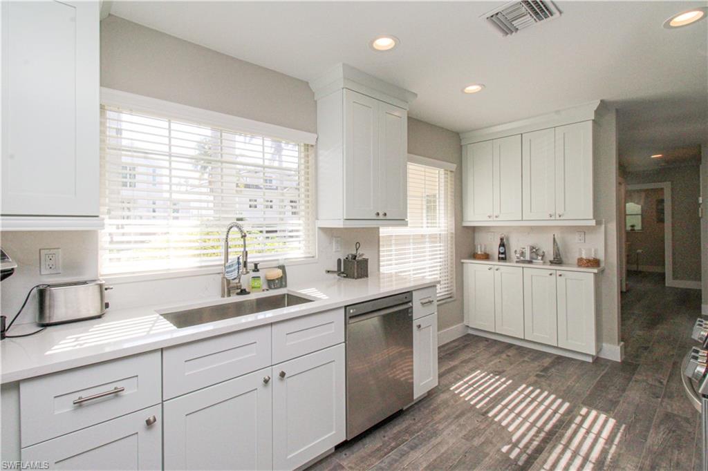 1353 Pelican Avenue Naples, FL 34102 - Photo 21 of 41 a kitchen with a sink window and cabinets