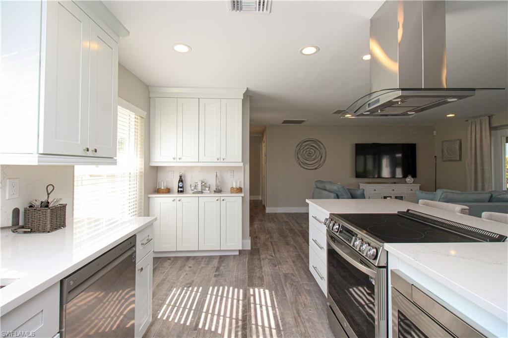 1353 Pelican Avenue Naples, FL 34102 - Photo 22 of 41 a kitchen with a sink and stove top oven