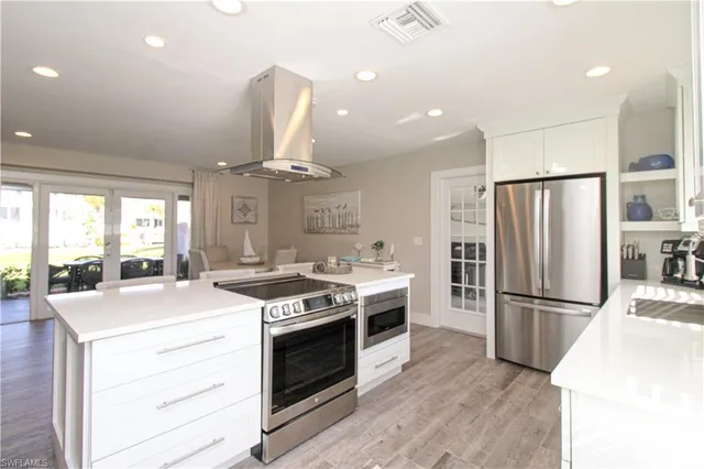 a kitchen with a stove a refrigerator and a sink
