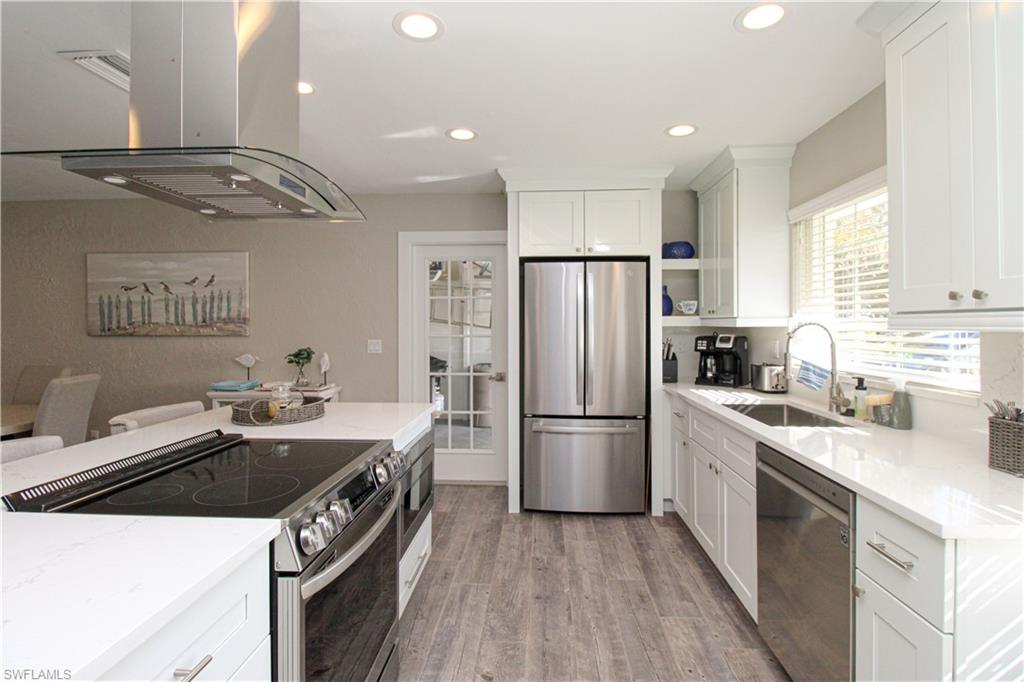 1353 Pelican Avenue Naples, FL 34102 - Photo 24 of 41 a kitchen with a sink a refrigerator a washer and dryer