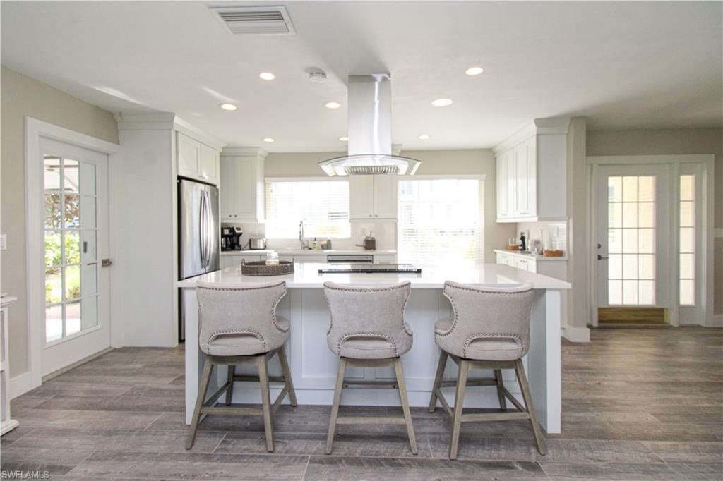1353 Pelican Avenue Naples, FL 34102 - Photo 25 of 41 a dining room with stainless steel appliances kitchen island granite countertop a dining table chairs and window