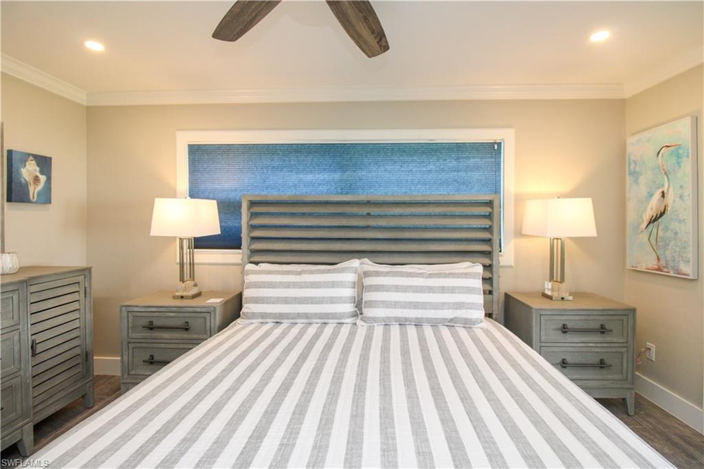 1353 Pelican Avenue Naples, FL 34102 - Photo 27 of 41 a bedroom with a bed and a lamp on dresser