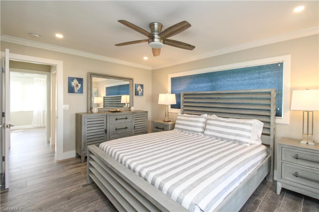 1353 Pelican Avenue Naples, FL 34102 - Photo 28 of 41 a bedroom with a bed and a chandelier