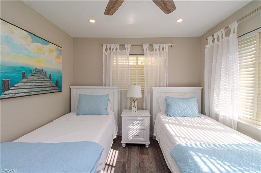 1353 Pelican Avenue Naples, FL 34102 - Photo 30 of 41 a bedroom with a large bed and a chandelier