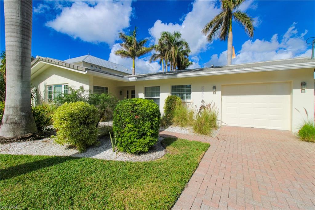 1353 Pelican Avenue Naples, FL 34102 - Photo 3 of 41 a front view of a house with a yard