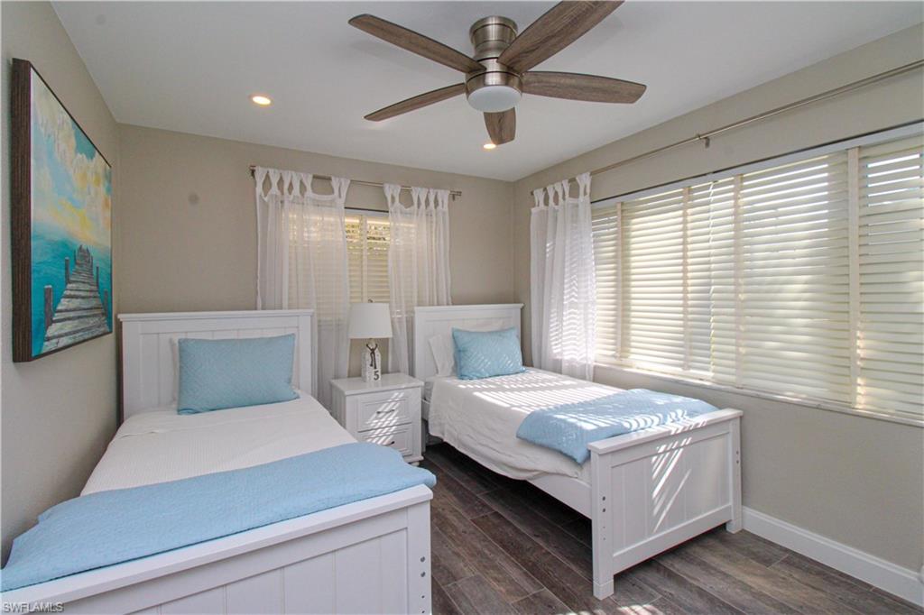 1353 Pelican Avenue Naples, FL 34102 - Photo 31 of 41 a bedroom with a large bed and a chandelier