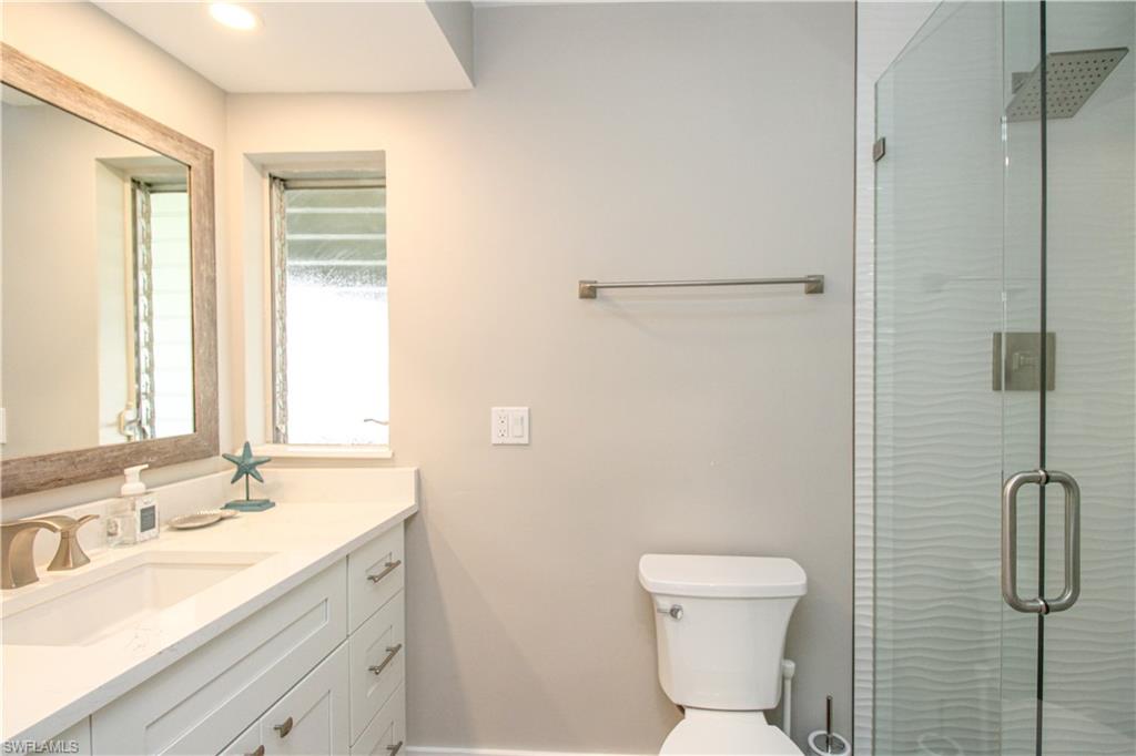 1353 Pelican Avenue Naples, FL 34102 - Photo 38 of 41 a bathroom with a granite countertop toilet sink and shower