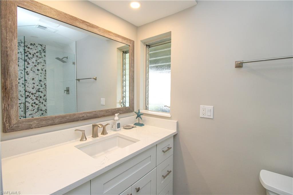 1353 Pelican Avenue Naples, FL 34102 - Photo 39 of 41 a bathroom with a sink and a mirror