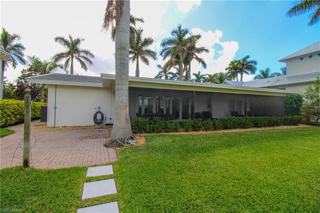 1353 Pelican Avenue Naples, FL 34102 - Photo 5 of 41 a view of a house with backyard and a garden