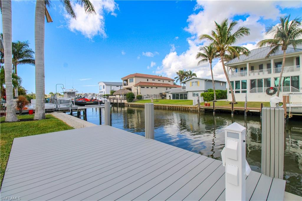 1353 Pelican Avenue Naples, FL 34102 - Photo 7 of 41 a front view of a house with a lake view