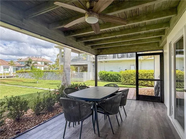 a view of a porch with furniture and wooden floor