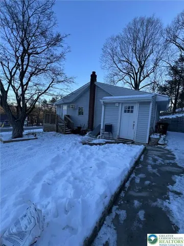 a backyard of a house with large trees and a large tree