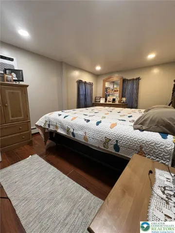 a bedroom with a bed and a dresser