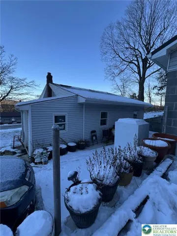 a view of a porch with furniture and a fire pit
