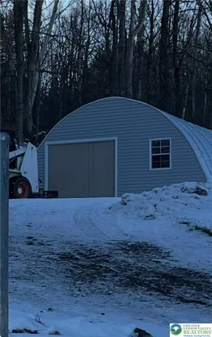 a backyard of house with a large tree