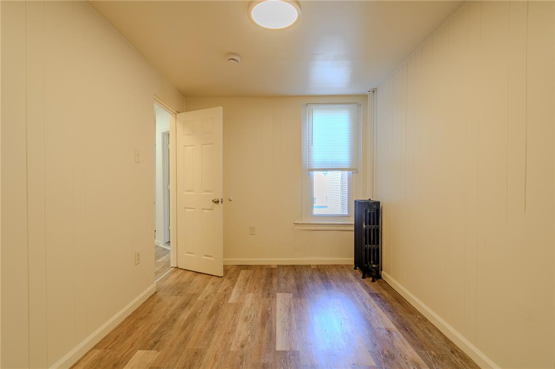820 North 5th Street Allentown, PA 18102 - Photo 29 of 39 Laminate wood flooring extends throughout this naturally lit room, offering an inviting blank canvas.