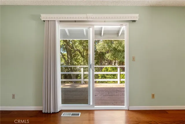 a view of a livingroom with a chandelier fan and a window