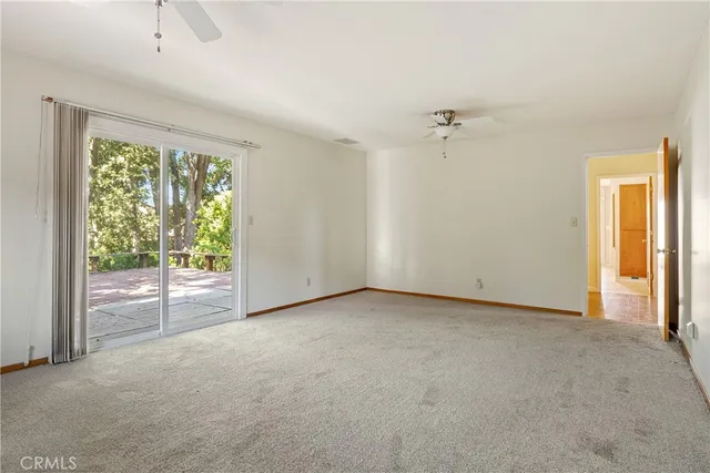 a view of a porch with furniture and floor to ceiling window