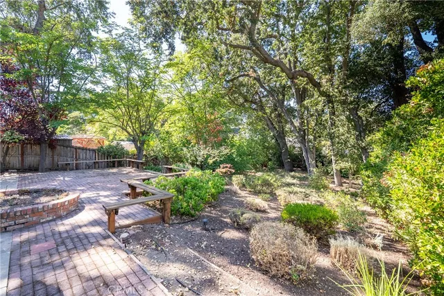 a view of a house with a tree in the forest