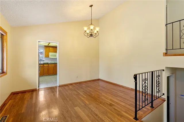 a kitchen with stainless steel appliances granite countertop a sink a stove cabinets and a window