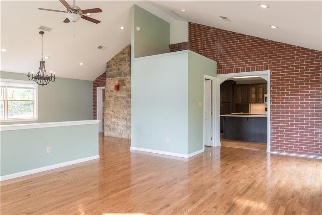4041 Dickey Road Gibsonia, PA 15044 - Photo 3 of 23 Exposed brick and the back of the stone fireplace provide a seamless transition from the original structure and add warmth to the space. The kitchen is through the entry on the right and a half bath is available just to the left of the kitchen entrance