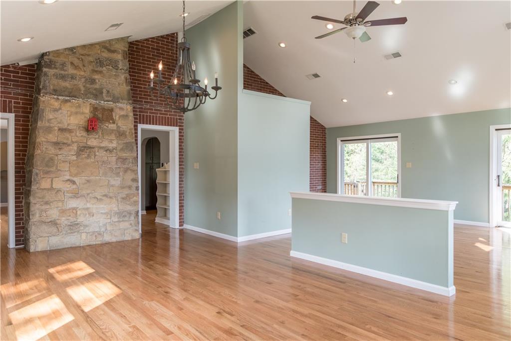 4041 Dickey Road Gibsonia, PA 15044 - Photo 4 of 23 Another view looking from the back of the great room. The double doors flanking the stone fireplace lead to the original living room. The sliding doors on the right lead to the deck and tranquil yard.