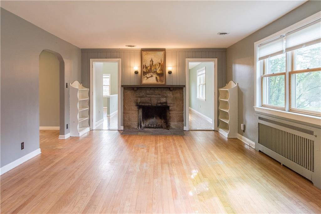 4041 Dickey Road Gibsonia, PA 15044 - Photo 6 of 23 Now that I've finished showing you the great room, let's head back to the bright front room with stone fireplace and built in shelving. It can be a more formal living room, an alternate dining space or whatever your heart can imagine! The kitchen is through the rounded archway on your left.