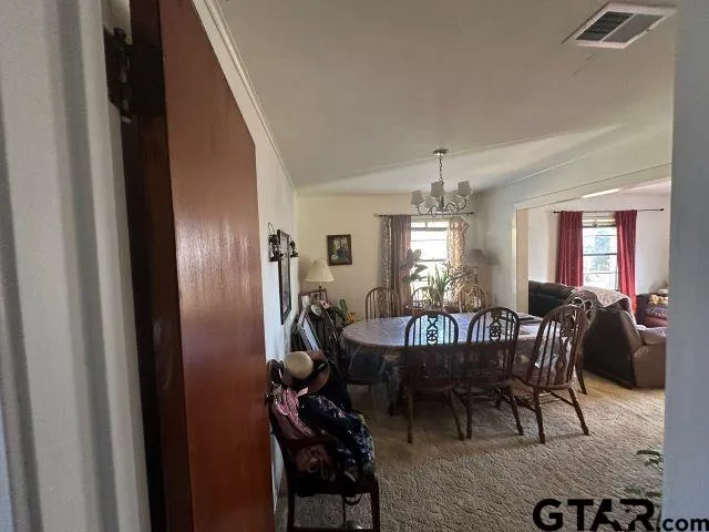 a view of a dining room with furniture and window