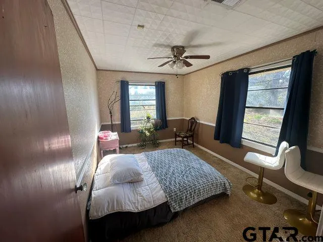 a bedroom with furniture and a window