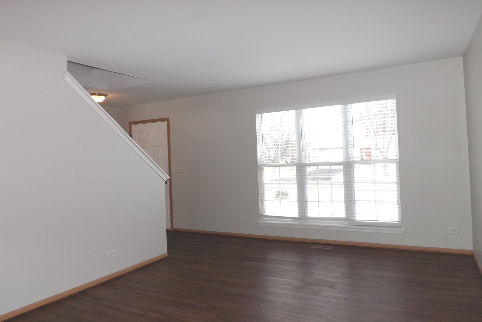 3312 Allen Street Plano, IL 60545 - Photo 3 of 21 an empty room with wooden floor and windows