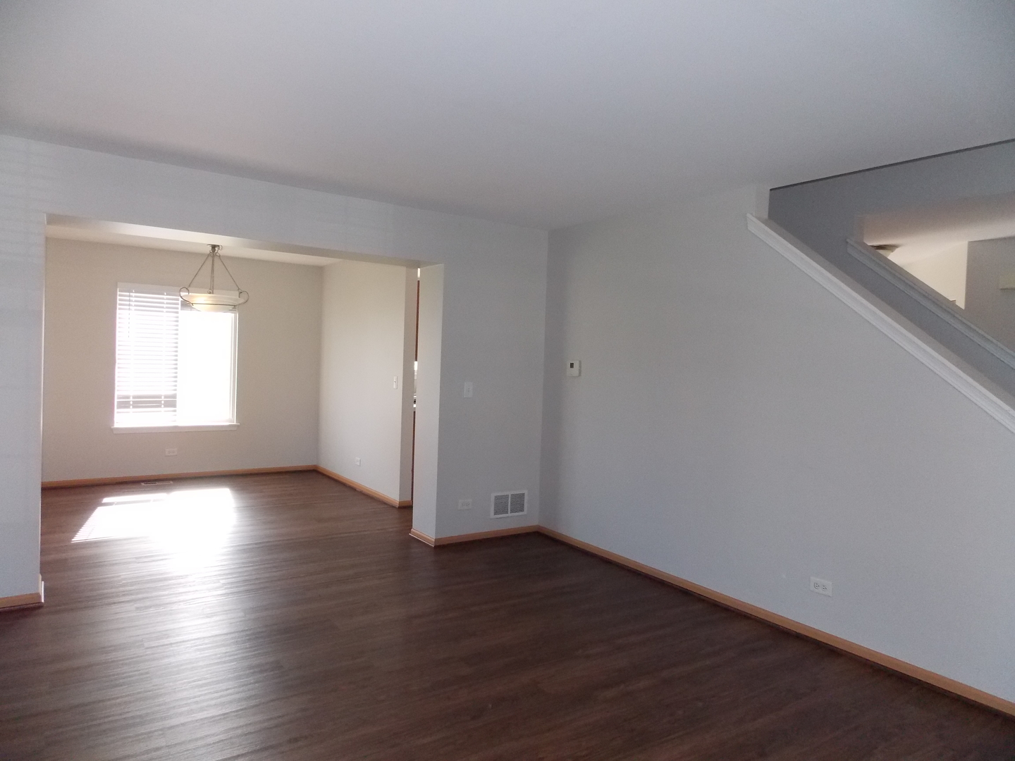 3312 Allen Street Plano, IL 60545 - Photo 4 of 21 a view of an empty room with wooden floor and a window