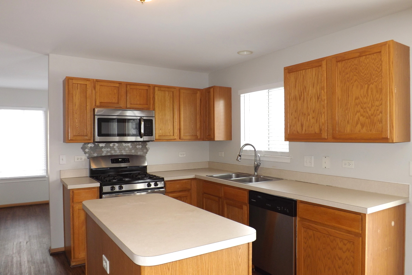 3312 Allen Street Plano, IL 60545 - Photo 6 of 21 a kitchen with stainless steel appliances a stove sink microwave and cabinets