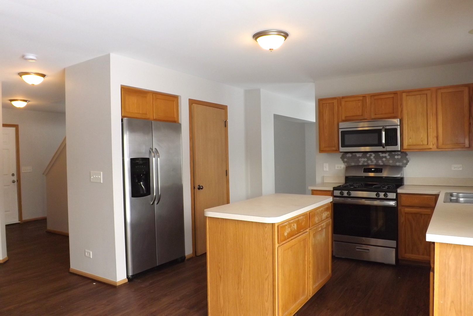 3312 Allen Street Plano, IL 60545 - Photo 7 of 21 a kitchen with a refrigerator and a stove top oven