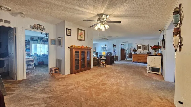 a view of a livingroom with a furniture and a ceiling fan
