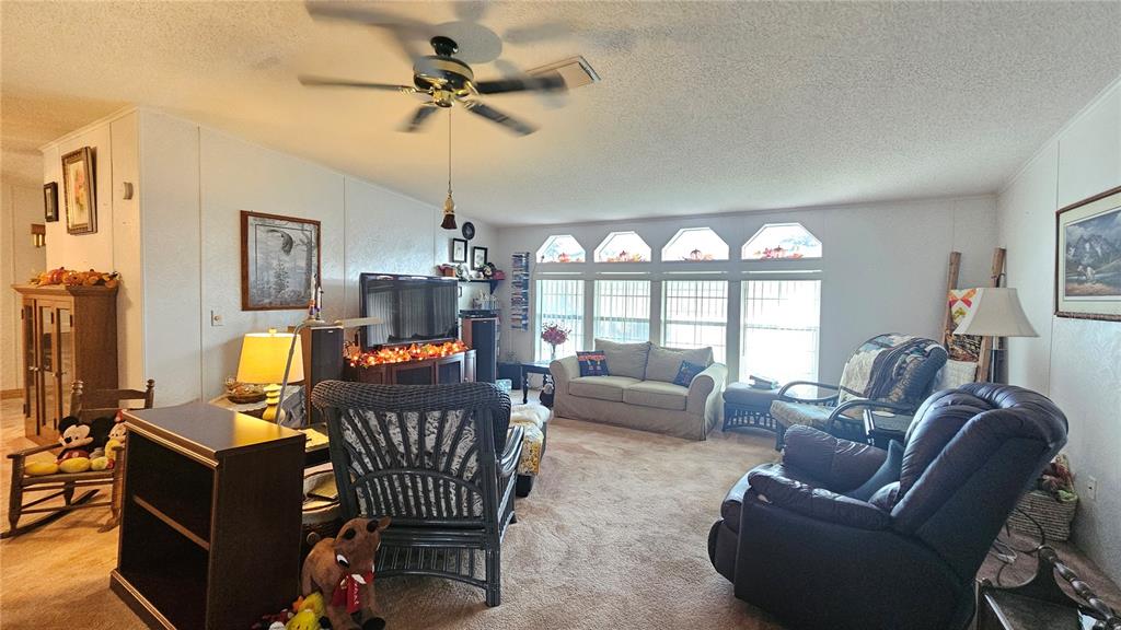 8210 Bull Run Drive New Port Richey, FL 34653 - Photo 14 of 30 a living room with furniture a chandelier and a window