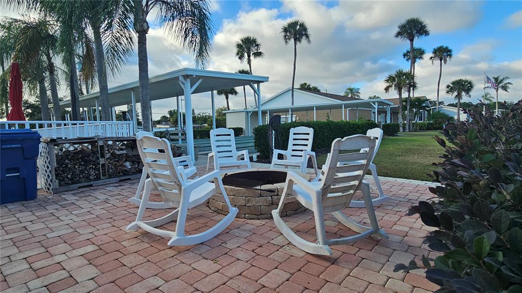 8210 Bull Run Drive New Port Richey, FL 34653 - Photo 25 of 30 a view of a chairs and table in backyard