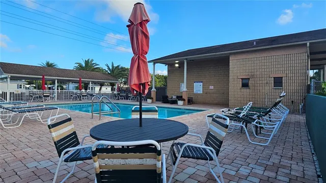 a swimming pool with outdoor seating