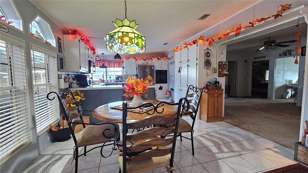 8210 Bull Run Drive New Port Richey, FL 34653 - Photo 7 of 30 a view of a dining room with furniture and chandelier