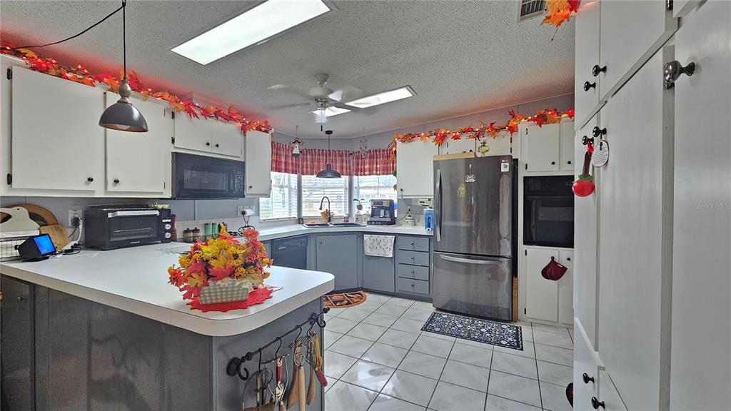 8210 Bull Run Drive New Port Richey, FL 34653 - Photo 8 of 30 a kitchen with stainless steel appliances a refrigerator sink and microwave