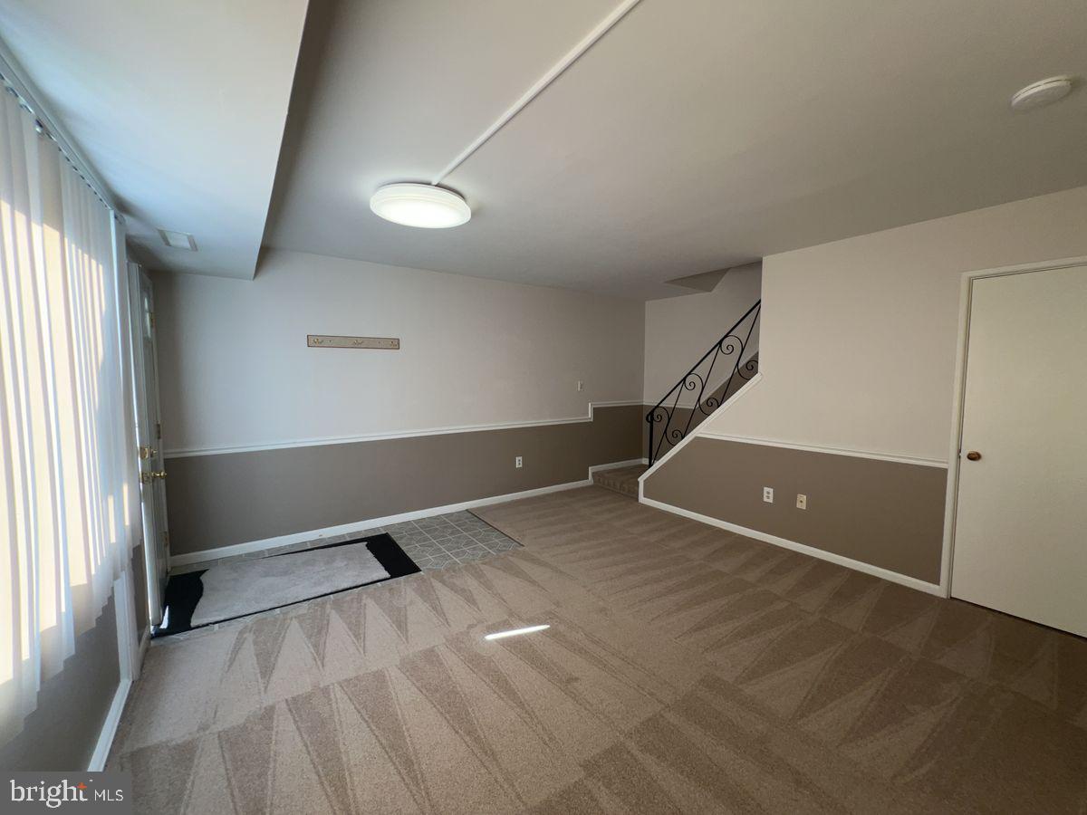 1002 Taney Avenue, Unit 1002 Frederick, MD 21702 - Photo 2 of 7 an empty room with a ceiling fan and window