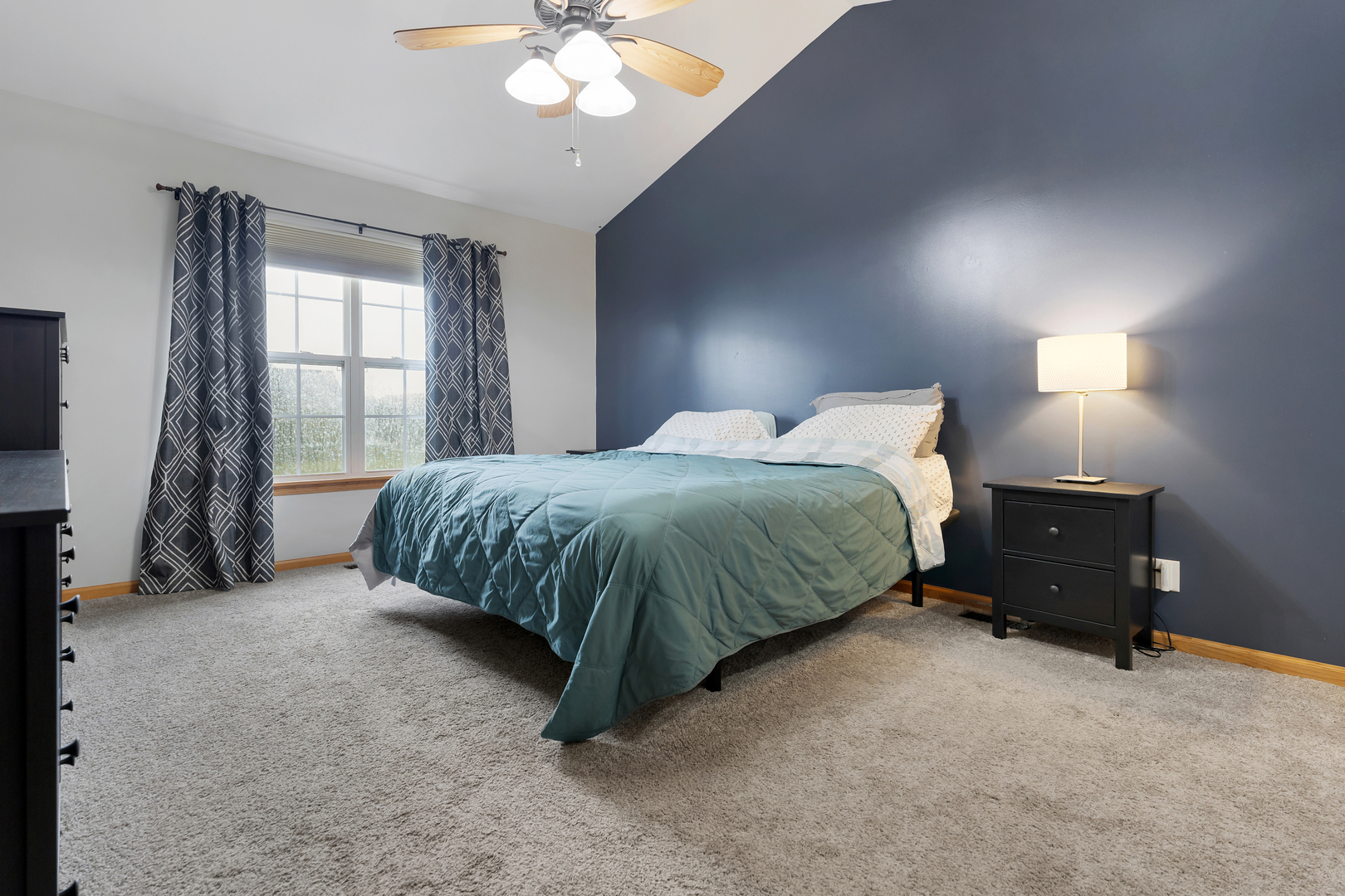 516 Clayton Circle, Unit 516 Sycamore, IL 60178 - Photo 15 of 26 a bedroom with a bed and a chandelier