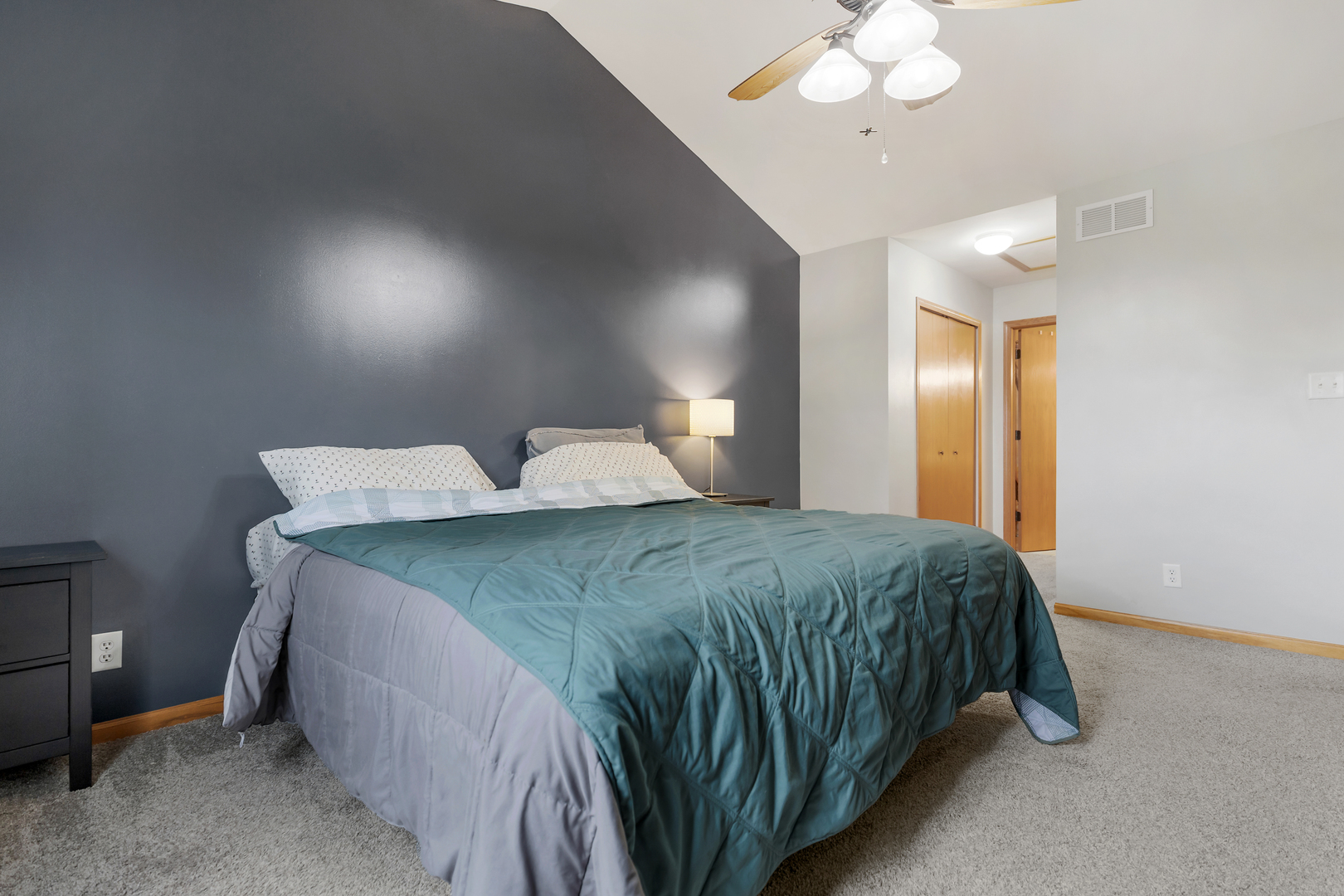 516 Clayton Circle, Unit 516 Sycamore, IL 60178 - Photo 16 of 26 a bedroom with a bed and a chandelier