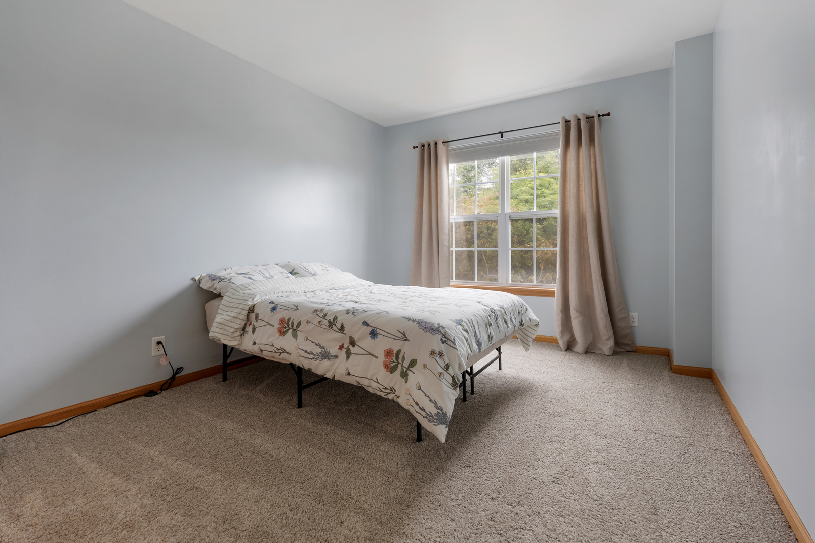 516 Clayton Circle, Unit 516 Sycamore, IL 60178 - Photo 18 of 26 a bed sitting in a bedroom next to a window