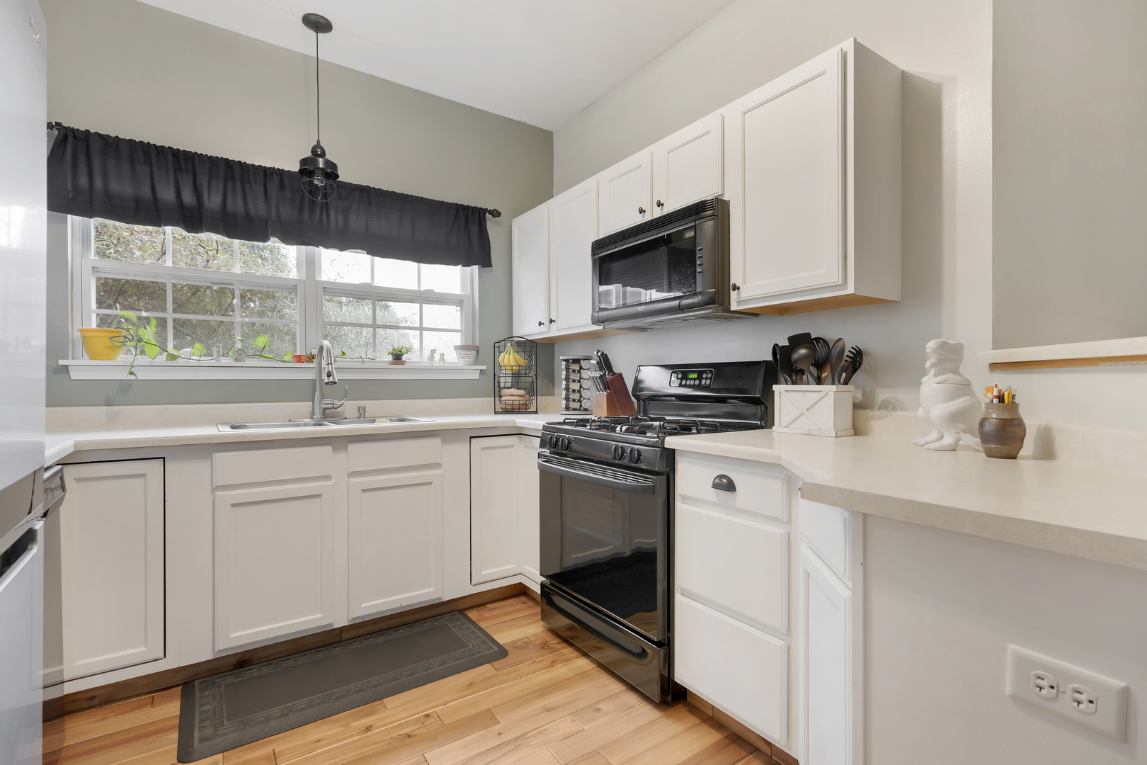516 Clayton Circle, Unit 516 Sycamore, IL 60178 - Photo 3 of 26 a kitchen with white cabinets appliances a sink and a window