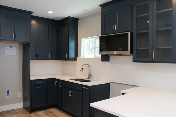 a kitchen with a sink and a microwave