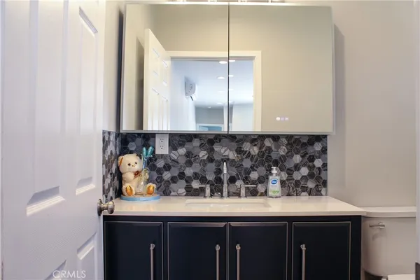 a large kitchen with stainless steel appliances granite countertop a sink and a stove