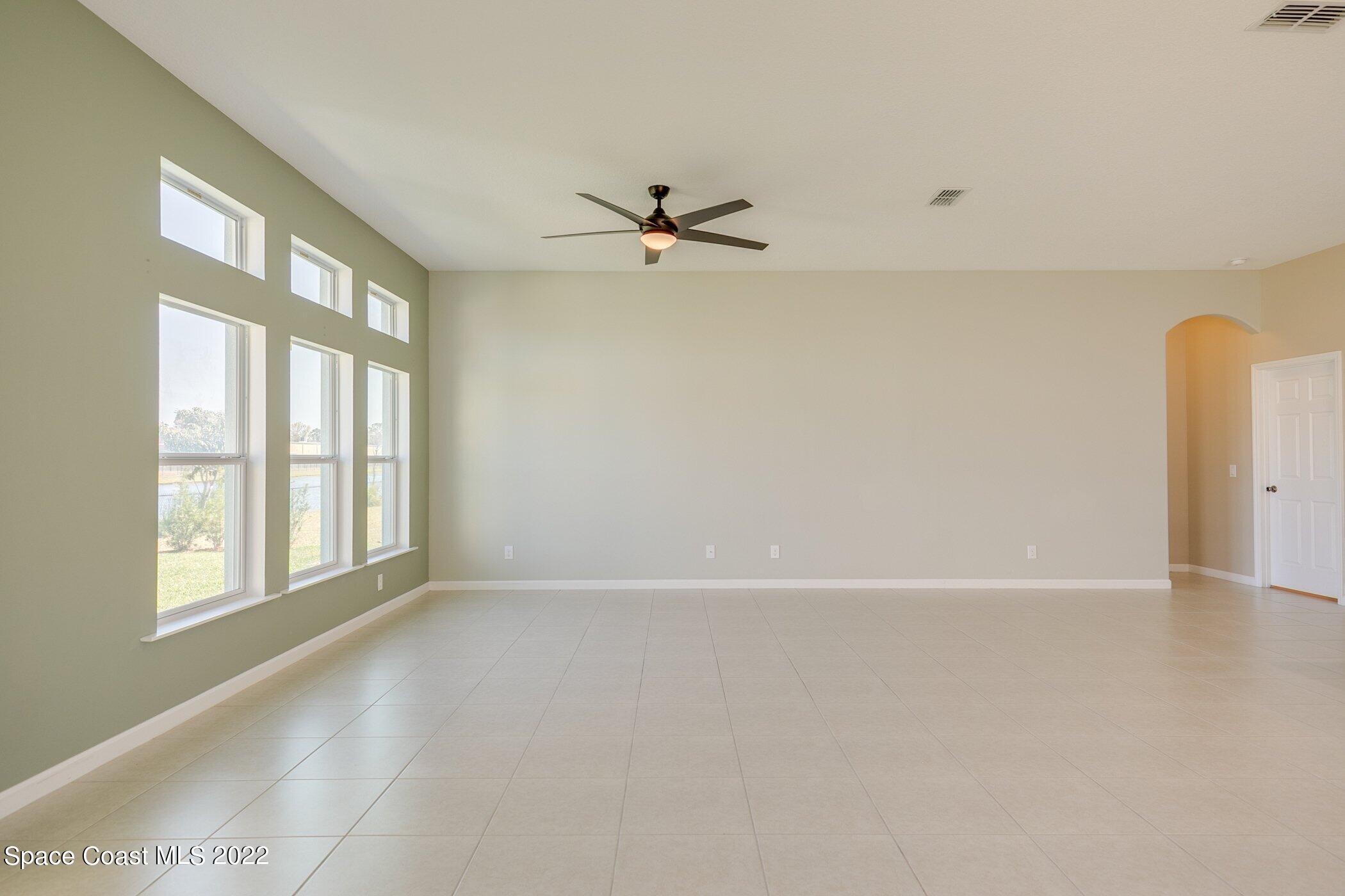 3555 Tabitha Court Melbourne, FL 32934 - Photo 17 of 30 an empty room with windows and fan