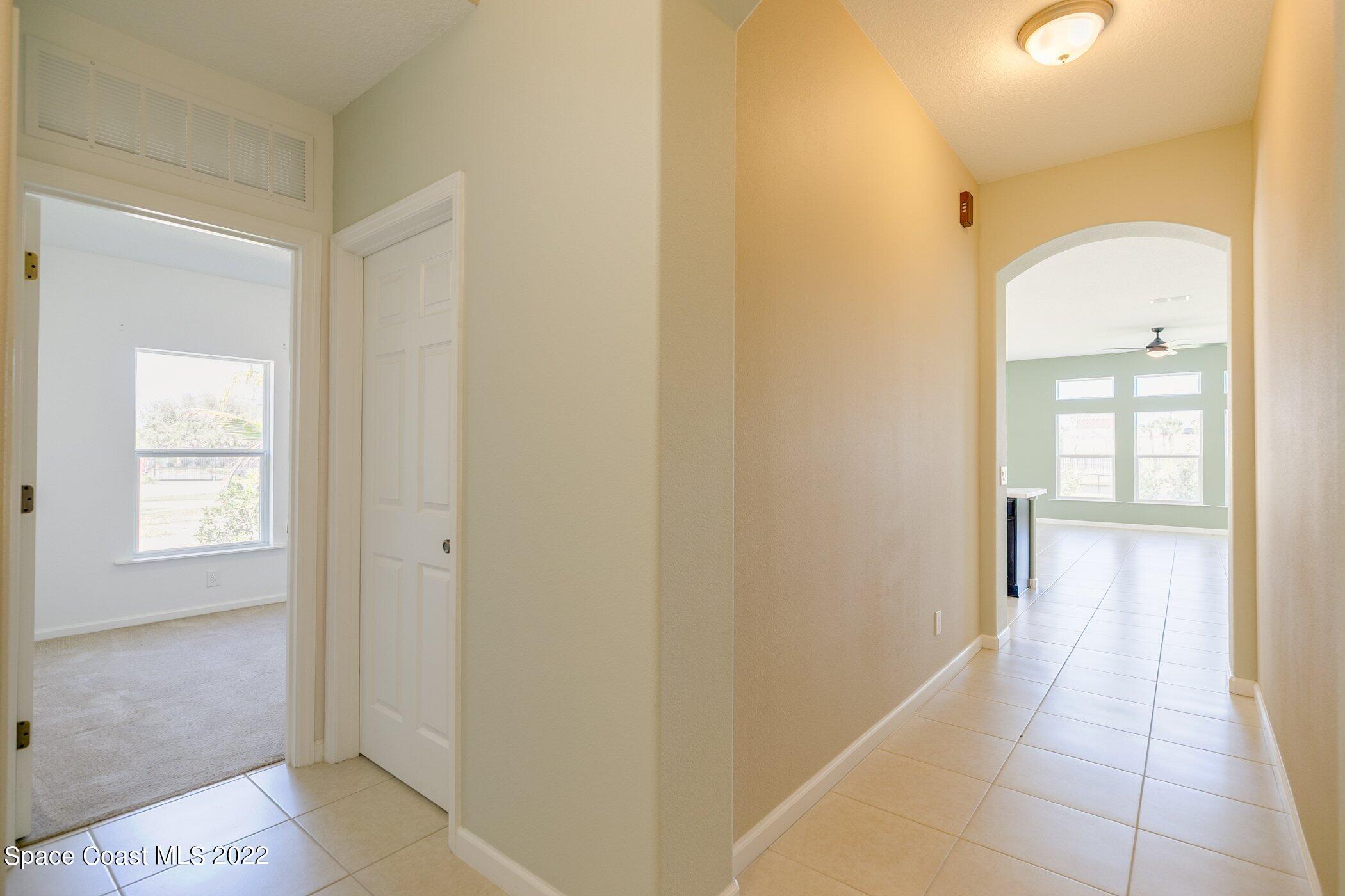 3555 Tabitha Court Melbourne, FL 32934 - Photo 4 of 30 a view of a hallway with windows and bathroom