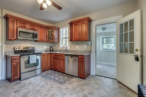 306 Dunstable Road Chelmsford, MA 01863 - Photo 4 of 18 a kitchen with stainless steel appliances granite countertop a stove sink and microwave